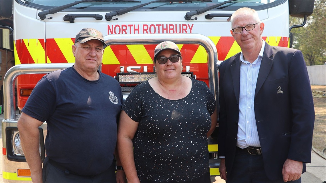 Image of North Rothbury Fire Brigade representatives Brett and Kelly standing in front of fire truck with Cessnock City Mayor Councillor Bob Pynsent